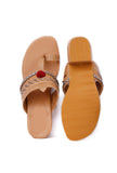 Stylish tan and silver heels with pom poms, made from cruelty-free leathe