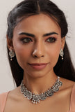 Silver oxidised Laxmi Devi necklace set with stud earrings featuring intricate handcrafted motifs from Saagah by Tjori