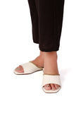 Woman wearing Irish white cruelty-free leather flat shoes with gold chain detail by Saagah by Tjori
