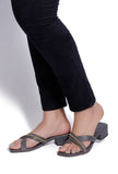 Woman wearing steel blue criss cross cruelty-free leather heels with gold chain strap by Saagah by Tjori