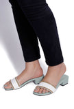Woman wearing ice blue and white cruelty-free leather heels with gold chain detail by Saagah by Tjori