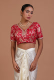 Red raw silk blouse with handcrafted embroidery for festive and bridal occasions by Tjori