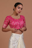 Pink raw silk blouse with handcrafted embroidery for festive and bridal occasions by Tjori