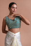 Light green raw silk blouse with intricate mirror work embellishment for festive and wedding wear by Tjori