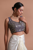 Blue raw silk blouse with intricate mirror work embellishment for festive and wedding wear by Tjori