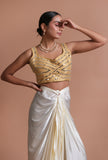 Golden raw silk blouse with intricate mirror work embellishment for festive and bridal occasions by Tjori