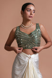 Bottle green raw silk blouse with intricate mirror work embellishment for festive and wedding wear by Tjori