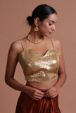 Golden raw silk blouse with handcrafted sitara work embellishment for festive and bridal occasions by Tjori