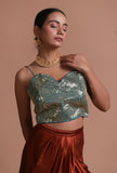 Green raw silk blouse with handcrafted sitara work embellishment for festive and wedding wear by Tjori