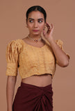 Golden cotton blouse with delicate chikankari embroidery for festive and wedding wear by Tjori