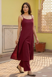 Woman wearing a red A-line cotton slip kurta with straight pants by Tjori