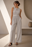 Woman wearing black and white striped sleeveless jumpsuit with keyhole neck by Tjori – front view