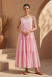 Woman wearing a blush pink cotton lace detail tiered gown by Tjori