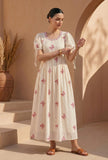 Woman wearing an ivory pink butterfly embroidered cotton gown by Tjori