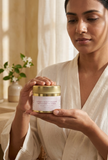 Woman in robe holding Natural Beauty Multani Mitti & Rose Face Pack jar in both hands