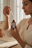 Using the dropper of the Kumkumadi saffron serum from the Glow Duo kit