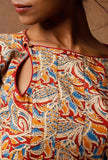 Close-up of Kalamkari cotton kurta neckline with keyhole cutout and red, blue and mustard block print detail