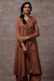 Woman wearing a taupe asymmetrical woollen kurta with aari embroidery by Tjori